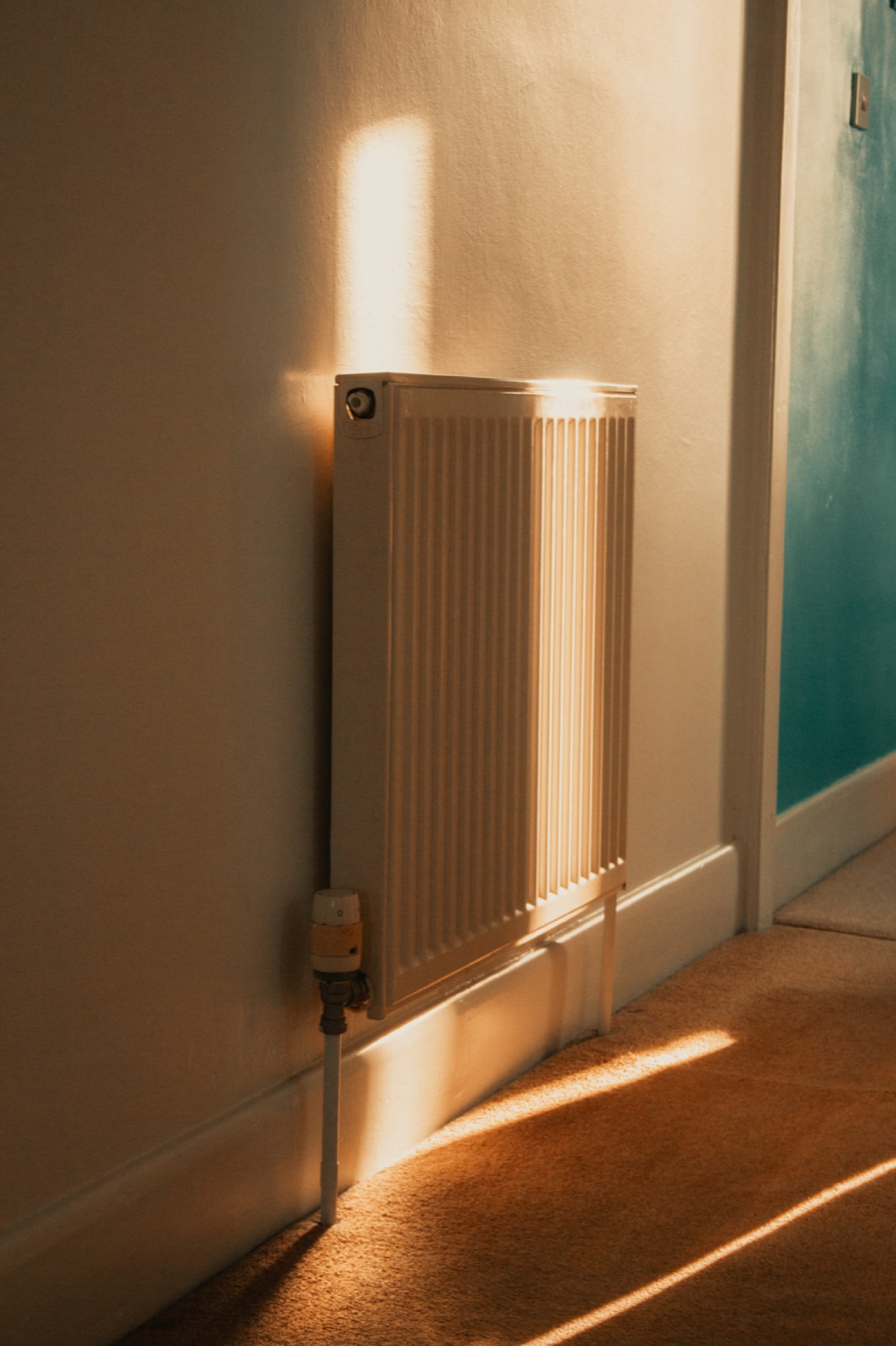 Radiateur mural baigné d'une lumière chaude dans un intérieur confortable
